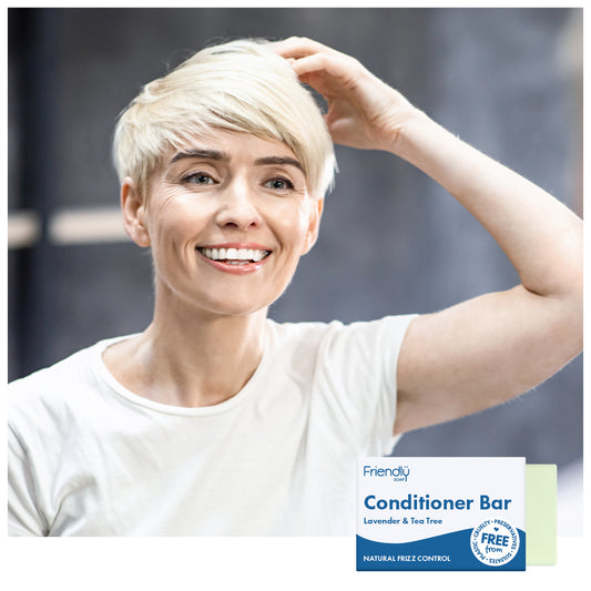 Woman with running her fingers through her short blonde hair