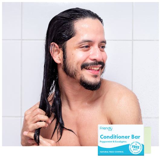 Man in shower using conditioner bar