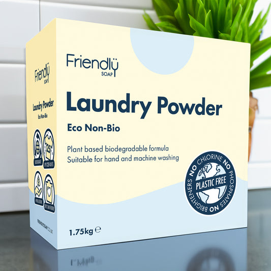 Box of Friendly Soap Eco Non-Bio laundry powder against a white background with a green plant beside it.