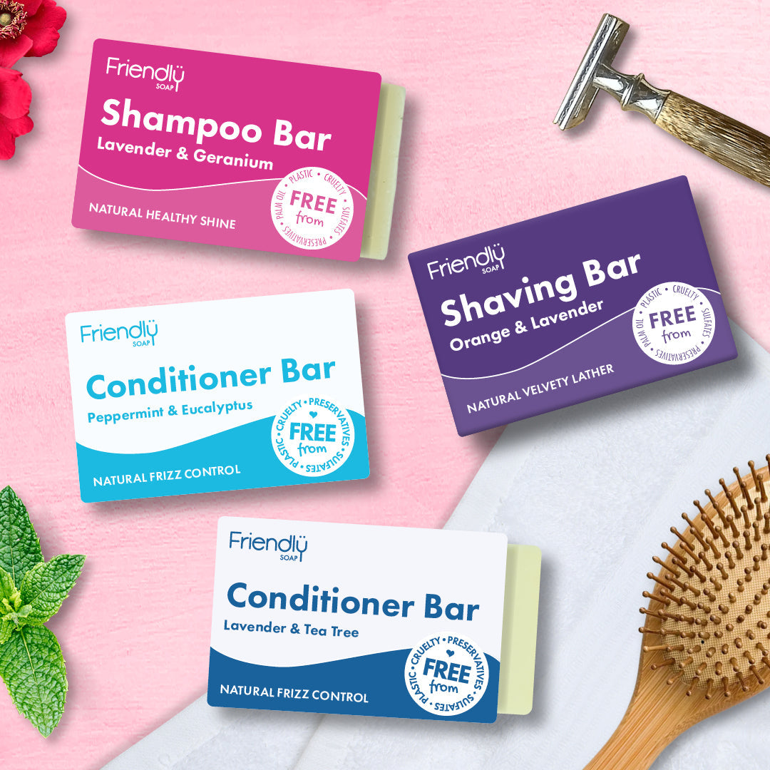 friendly soap shampoo and conditioner bars on a bathroom table with a wooden hair brush