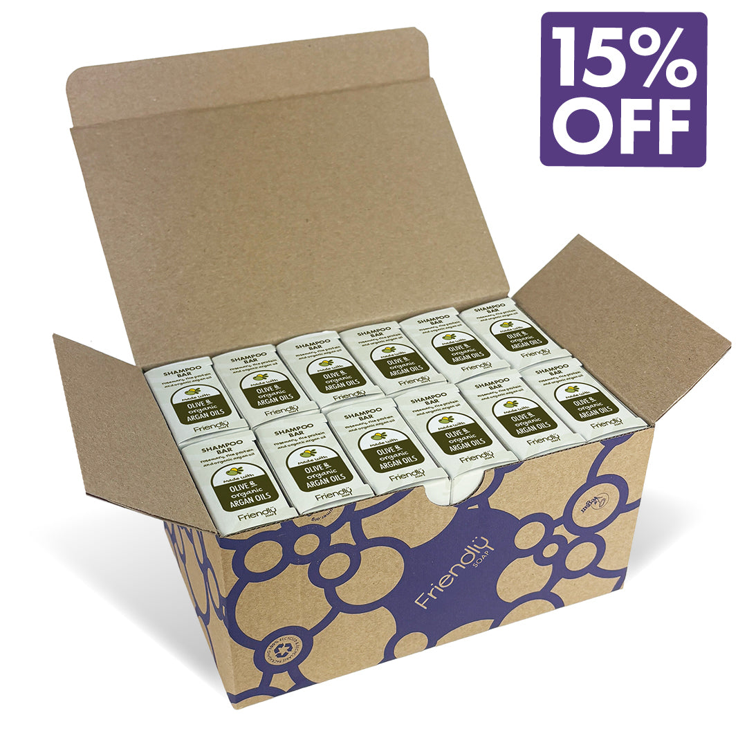 An open brown cardboard box filled with 12  shampoo bars on a white background with a purple '15% OFF' badge in the top right. The box has a blue floral pattern and the brand name 'Friendly Soap' printed on it.