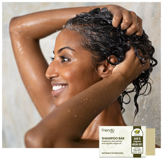 smiling young woman in shower enjoying a friendly soap shampoo bar with rosemary, rice protein and organic argan oil