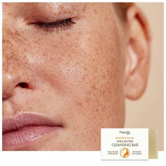 close up of white womans face with freckles small shea butter cleansing bar in bottom right corner