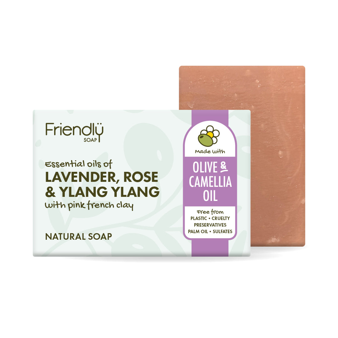 A bar of natural olive oil soap with 'Olive & Camellia Oil, shown with its white and purple packaging box and a terracotta-colored soap bar behind it on a white background.