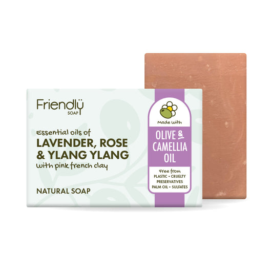 A bar of natural olive oil soap with 'Olive & Camellia Oil, shown with its white and purple packaging box and a terracotta-colored soap bar behind it on a white background.