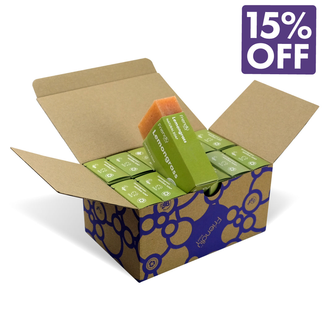 An open kraft cardboard box containing 12 lemongrass soap bars, with one soap bar standing upright and showing the brand name 'Friendly'. A purple '15% OFF' promotional badge is overlaid in the top right corner on a clean white background.
