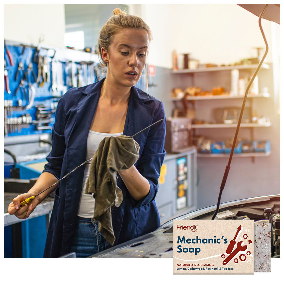 female mechanic checking the oil in a garage with a friendly soap mechanics soap bar