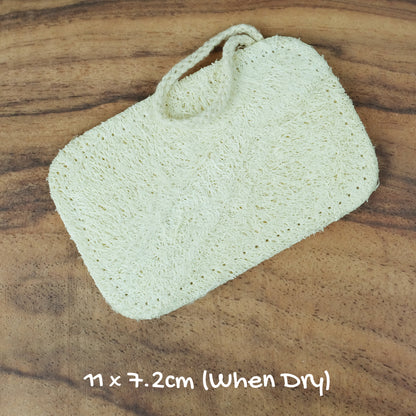 dry small shower loofah exfoliator on wooden surface