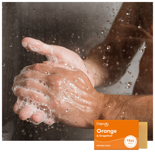 man's hands lathering up in the shower - friendly soap orange & grapefruit 