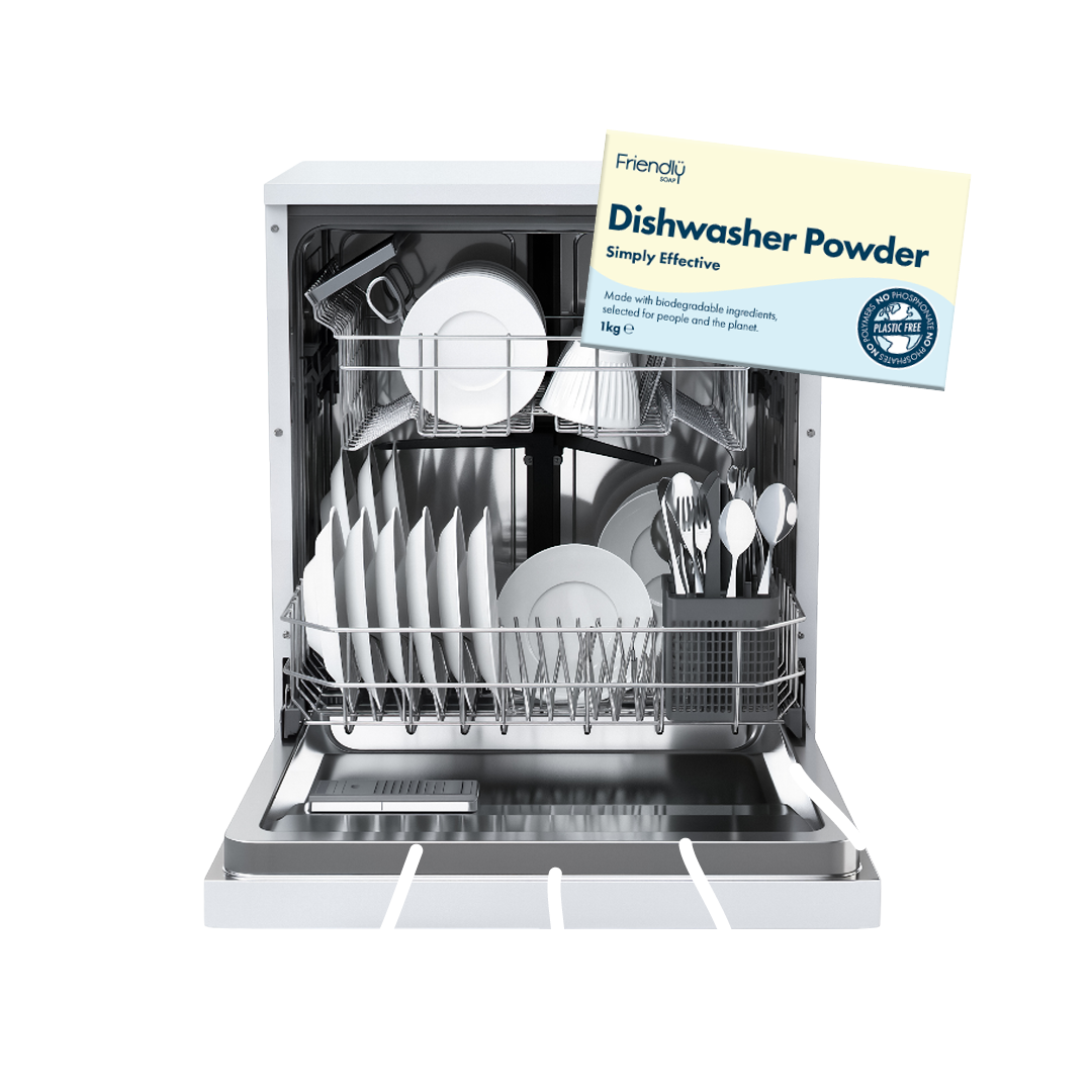 A white dishwasher with its door open, showing clean white dishes inside, alongside a package of Friendly Dishwasher Powder hanging in front. The background is solid white.